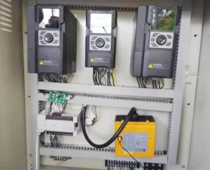 XFC500 VFDs installed in a rebar cage winding machine control cabinet with PLC wiring